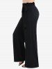 Ensemble grande taille composé d'un haut asymétrique à épaules dénudées, lacé et orné de sequins scintillants, et d'un pantalon large à volants. - Bleu profond 
