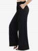 Ensemble grande taille composé d'un haut asymétrique à épaules dénudées, lacé et orné de sequins scintillants, et d'un pantalon large à volants. - Bleu profond 